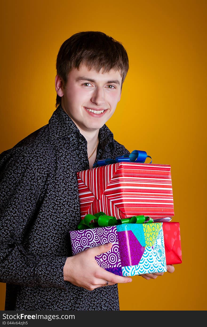 Present gift holding man looking smiling. Present gift holding man looking smiling