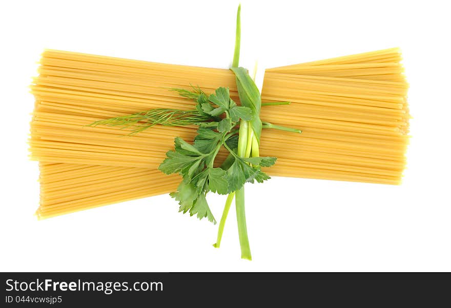 Bunch of raw pasta (spaghetti) tied with fresh green onion  on white background with copy space. Bunch of raw pasta (spaghetti) tied with fresh green onion  on white background with copy space