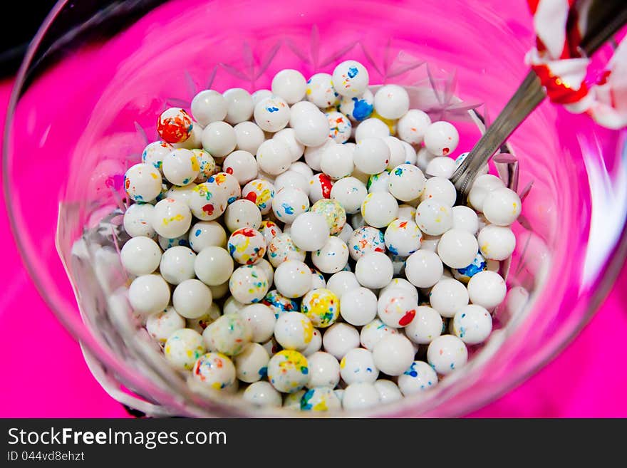 A vase filled with white ball candy. A vase filled with white ball candy.