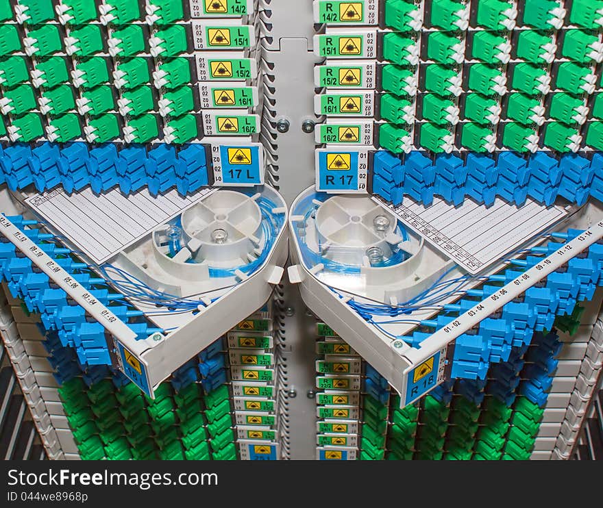 Fiber optic cable management system with green and blue SC connectors. Fiber optic cable management system with green and blue SC connectors