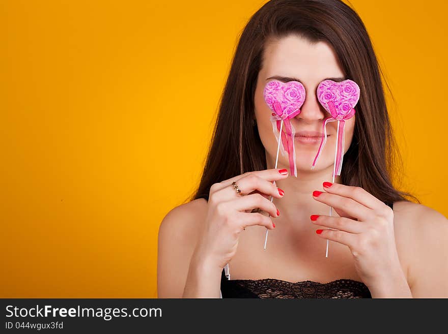 Beautiful young  woman with hearts in her hand