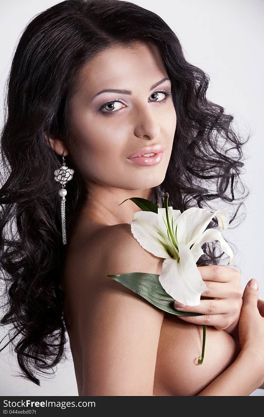 Beautiful young woman with lily flower.