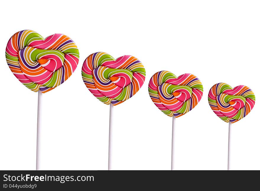 Colorful heart-shaped lollipops on white background. Colorful heart-shaped lollipops on white background