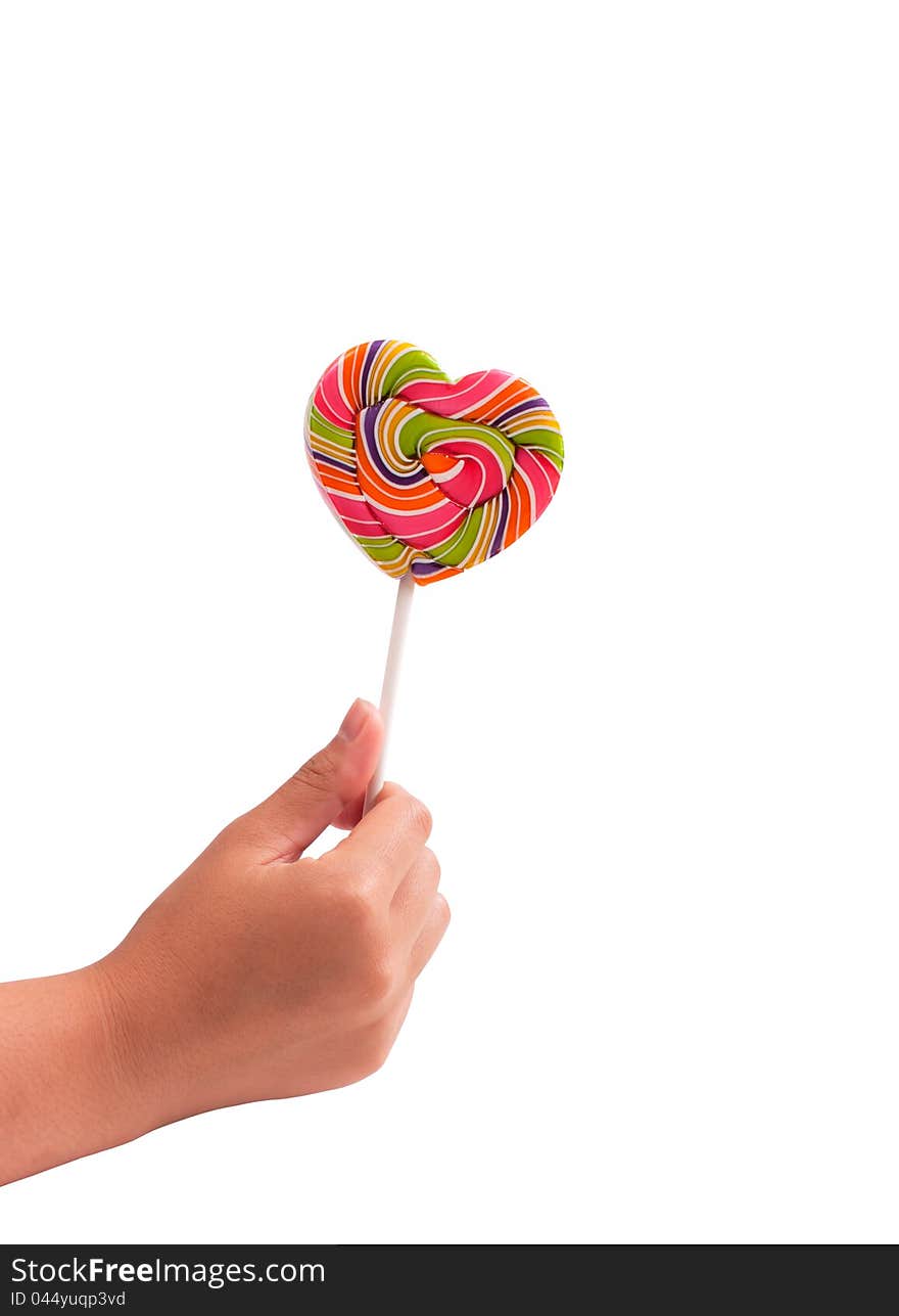 Hand holding heart-shaped lollipops colorful on white background. Hand holding heart-shaped lollipops colorful on white background