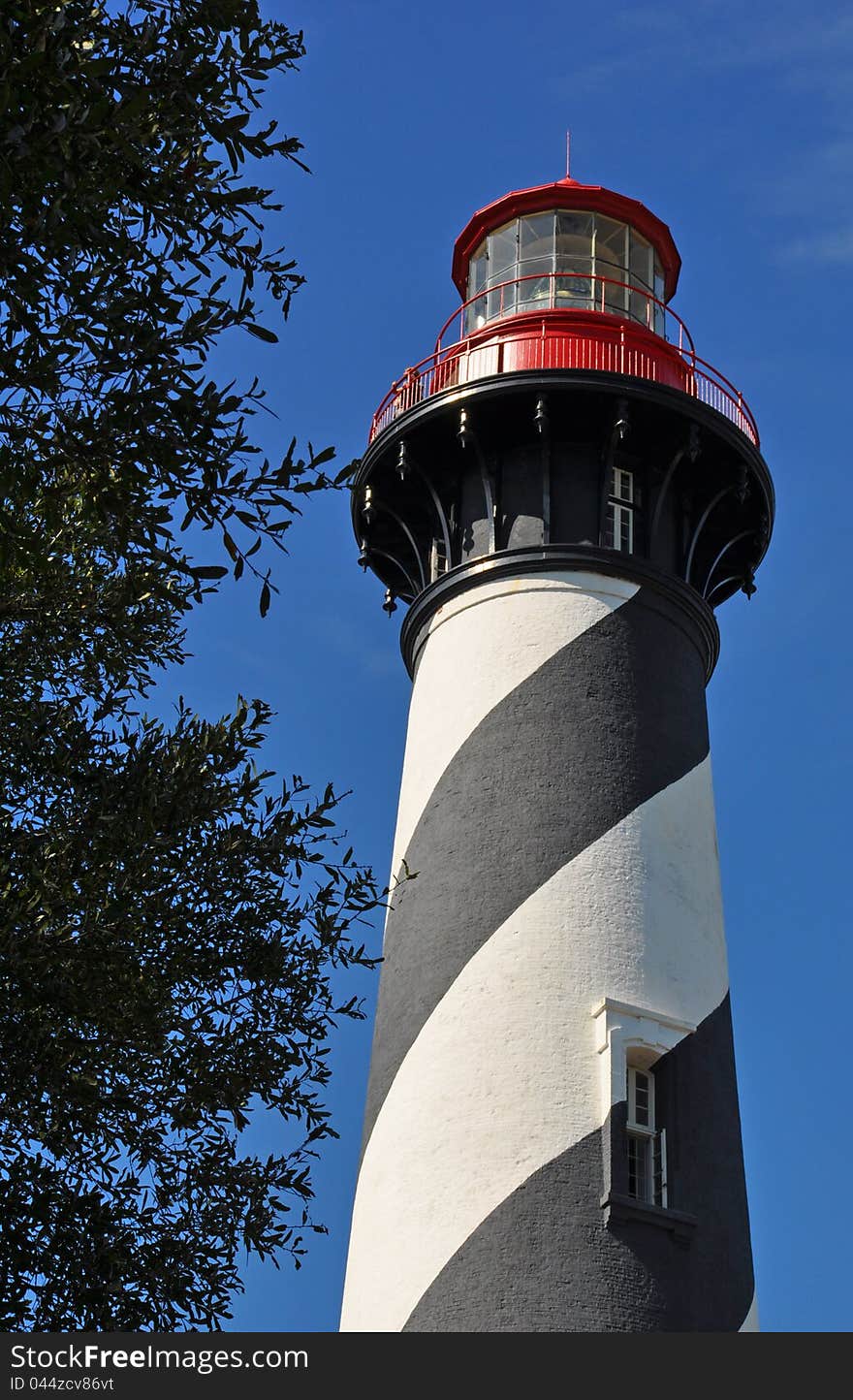 Striped Historic Lighthouse Against Blue Sky