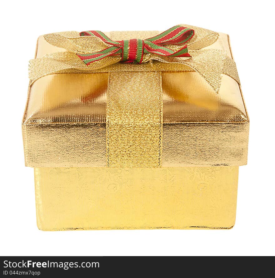 Closed gold gift box with bow and ribbon on a white background