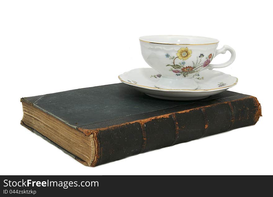 Book and a cup of china on a white background. Book and a cup of china on a white background