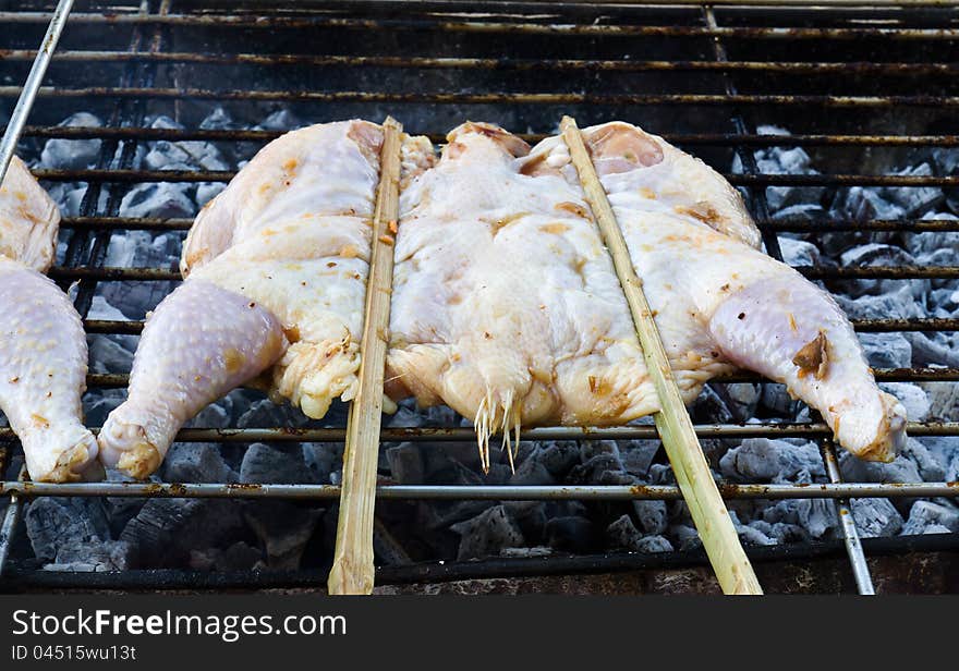 Roasting chicken on the chargrill. Roasting chicken on the chargrill