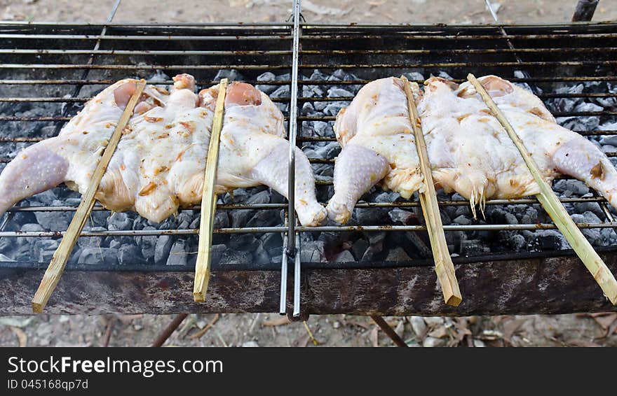 Roasting chicken on the chargrill. Roasting chicken on the chargrill