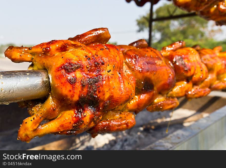 Image of delicious roasted chicken on the spit. Image of delicious roasted chicken on the spit