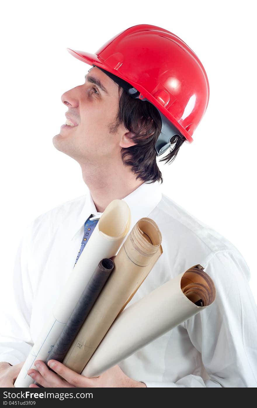 Portrait of young smiling engineer holding blueprints and looking up isolated on white.