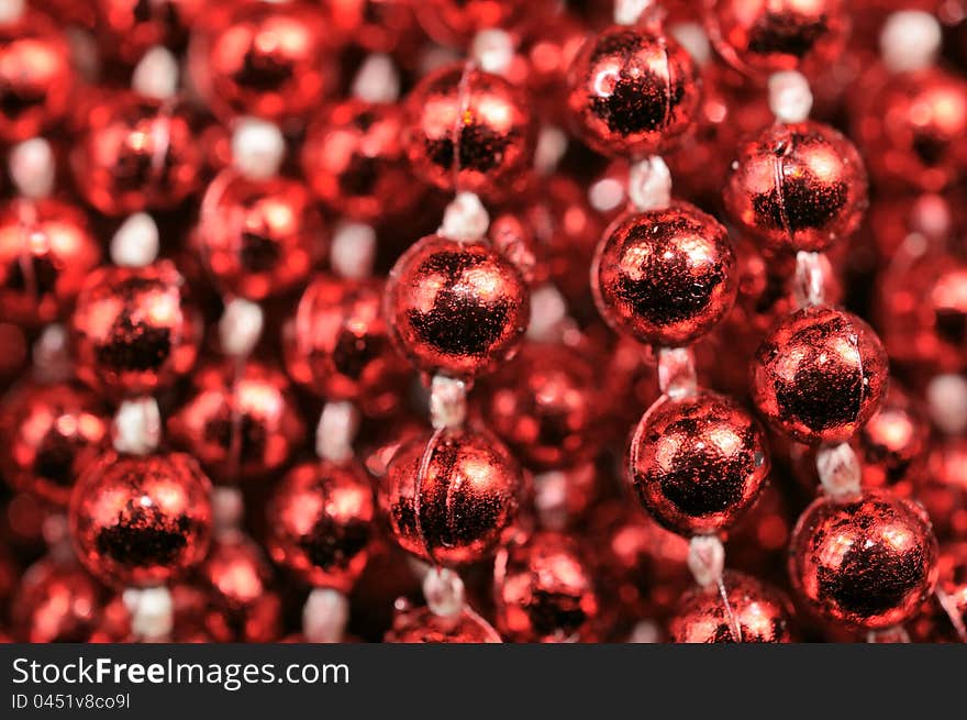 A shiny red Christmas bead garland as a background