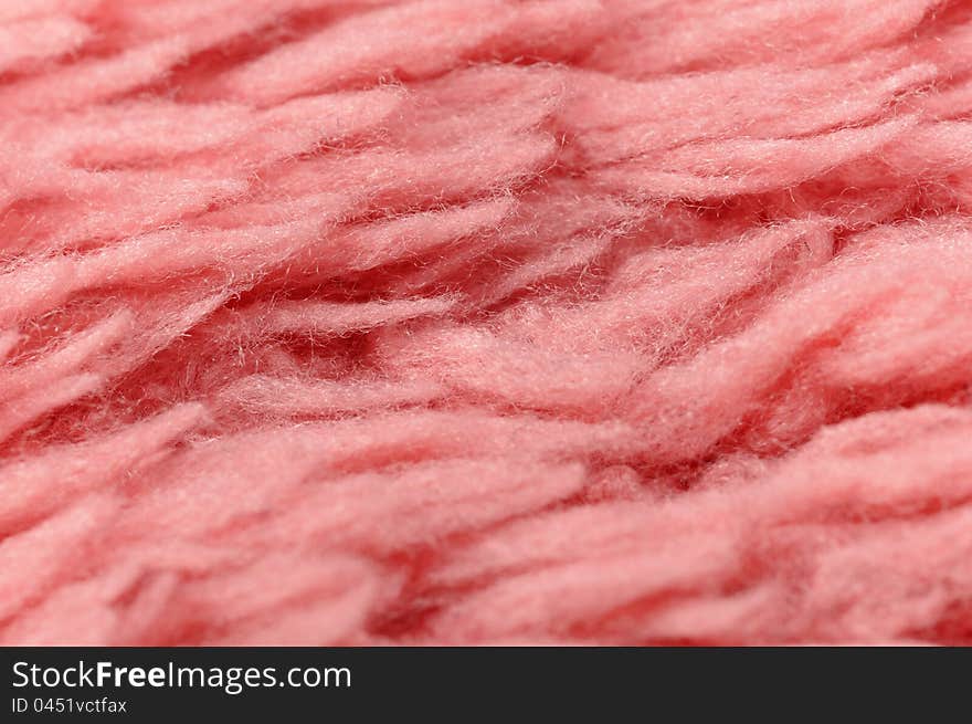 A fluffy pink cloth texture close-up