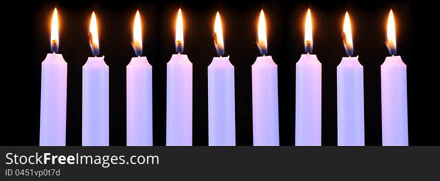 Nine burning candles on a black background. Nine burning candles on a black background