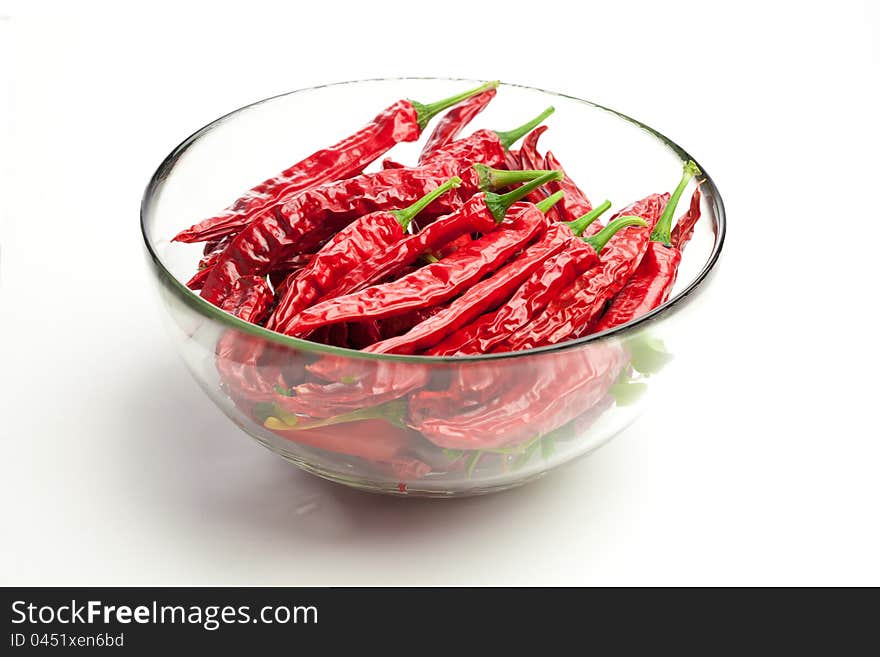 Red chili peppers in the glass bowl,  on white. Red chili peppers in the glass bowl,  on white