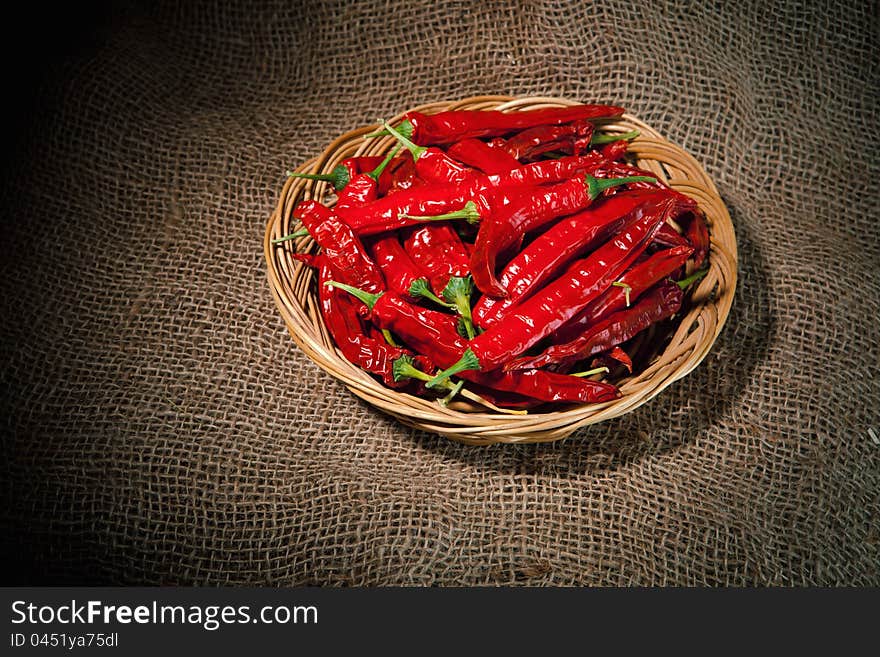 Red chili peppers on the wicker dish