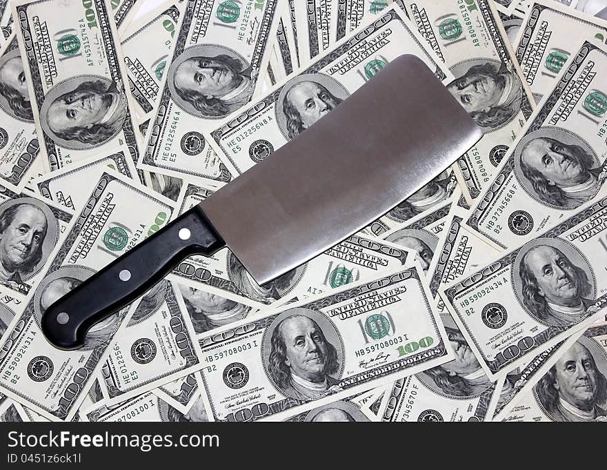 Hatchet lying on the one hundred dollar bills. Hatchet lying on the one hundred dollar bills