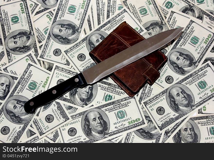 Knife and a purse lying on the 100 dollar bills. Knife and a purse lying on the 100 dollar bills