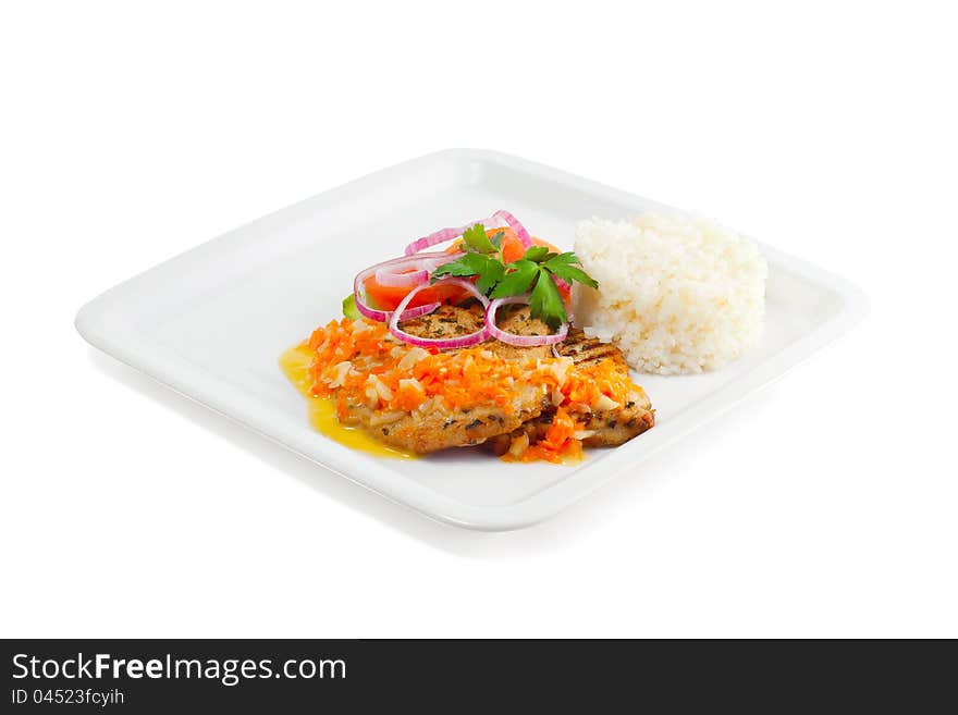 Rice with meat, vegetables and sauce on a white background