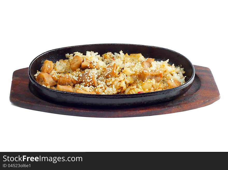 Rice and meat fried in a frying pan