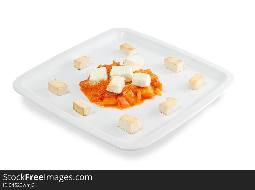 Slices of fried cheese with grilled vegetables on a white background