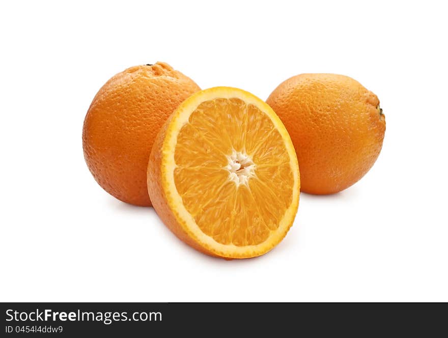 Two oranges and a half of orange in the foreground