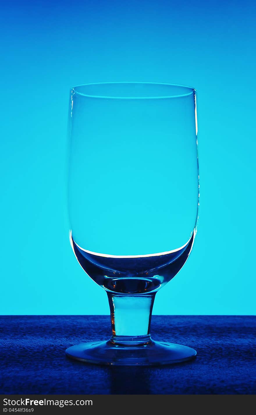 Glass for wine on a dark blue background