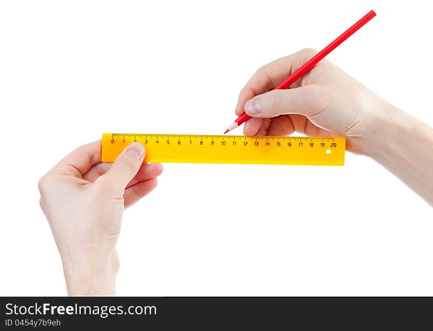 Yellow Ruller And Red Pencil In Hands Isolated