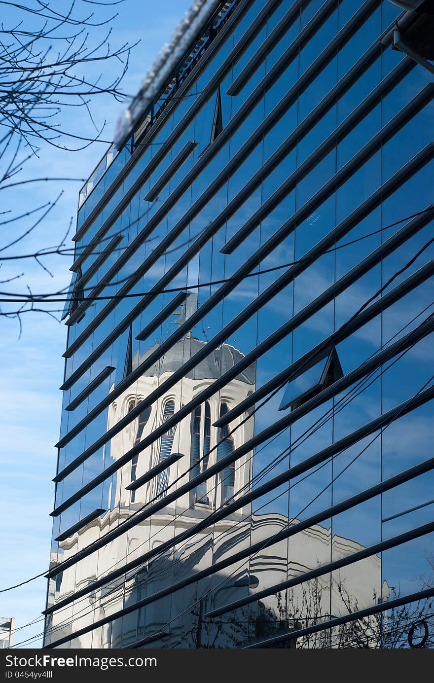 Image of an old church on a modern curtain wall. Image of an old church on a modern curtain wall