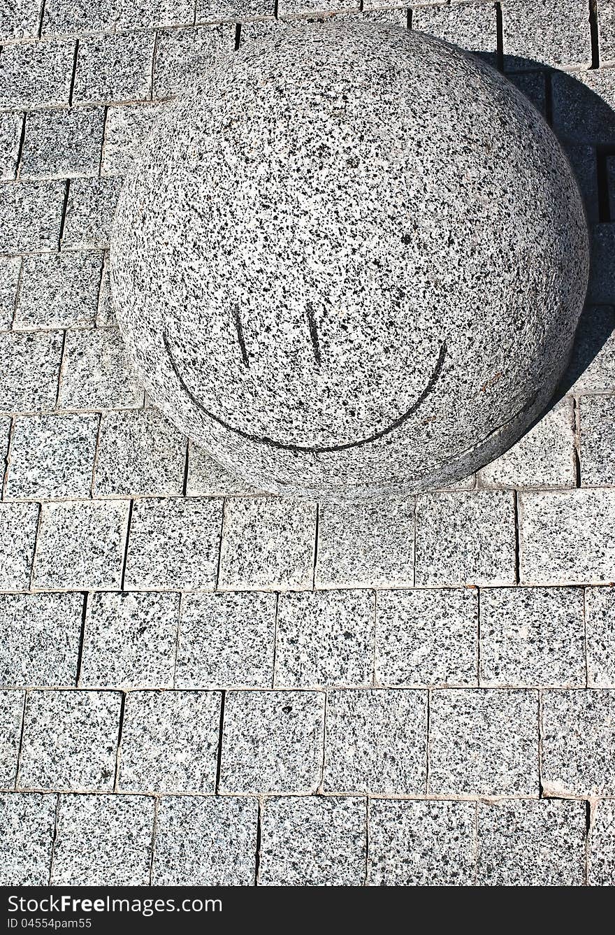 Smiling stone in city street. Smiling stone in city street