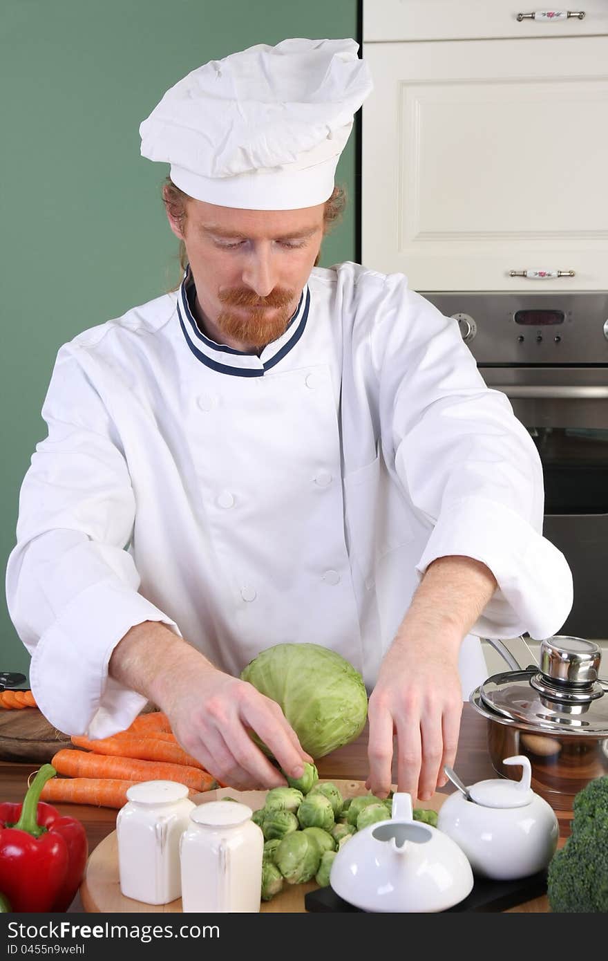 Young chef preparing lunch in kitchen