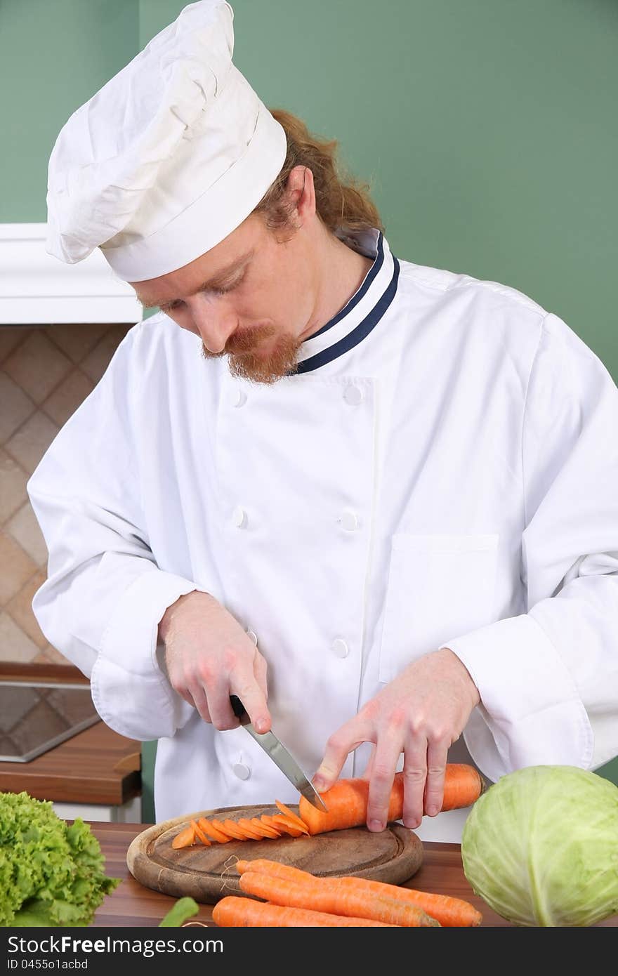 Young chef preparing lunch in kitchen