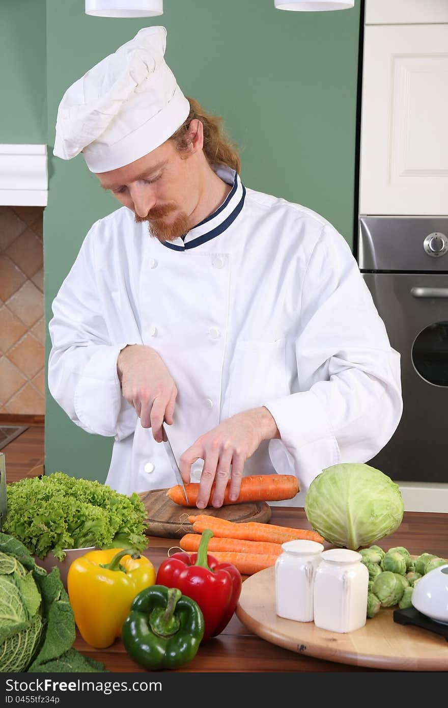 Young chef preparing lunch in kitchen