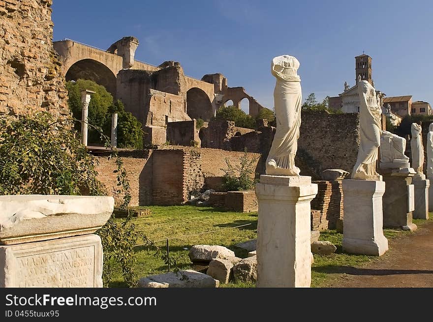 Ancient Roman statues stand on pedestals in the open air in Rome. Ancient Roman statues stand on pedestals in the open air in Rome