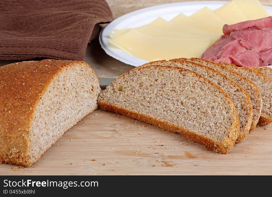 Rye bread sliced on a cutting board for making sandwiches