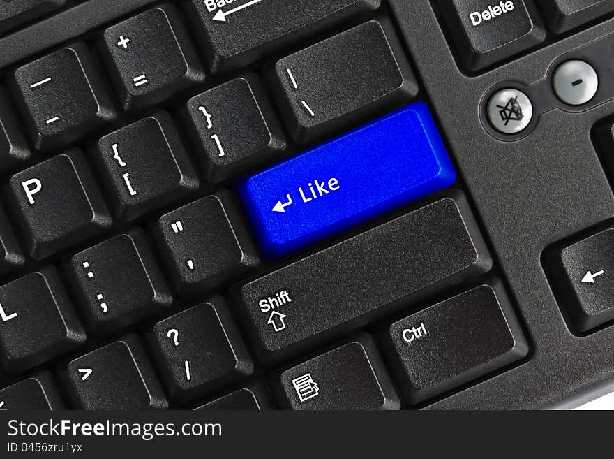 Close up of black pc keyboard, focus on blue like key, like concept. Close up of black pc keyboard, focus on blue like key, like concept