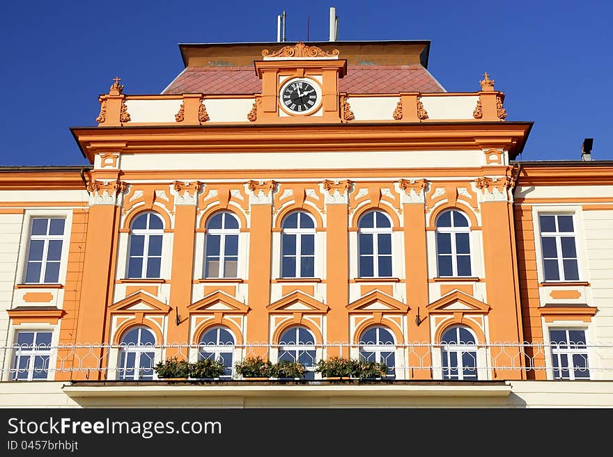 Detail of a middle part of an art nouveau building with balcony and clock. Detail of a middle part of an art nouveau building with balcony and clock