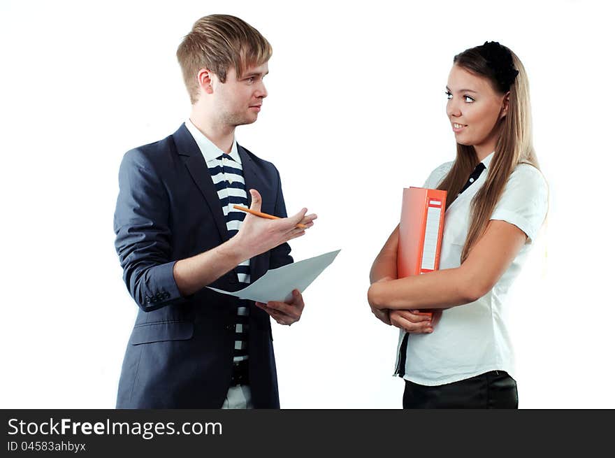 Portrait of a young men explaining something to pretty young women holding paper and pencil isolated on white background. Portrait of a young men explaining something to pretty young women holding paper and pencil isolated on white background