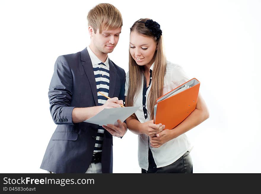 Portrait of a young men explaining something to pretty young women holding paper and pencil isolated on white background. Portrait of a young men explaining something to pretty young women holding paper and pencil isolated on white background