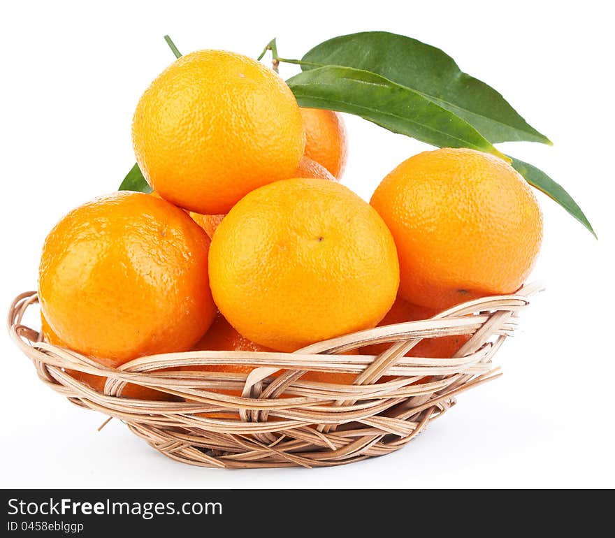 Tangerines with leaves in a beautiful basket  on white