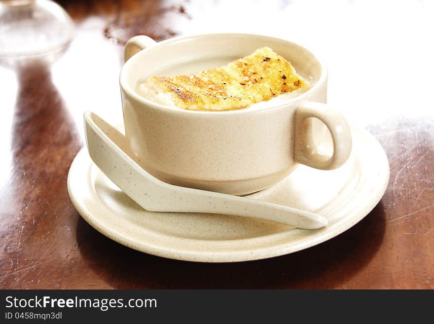 Creme soup with mushrooms in white bowl