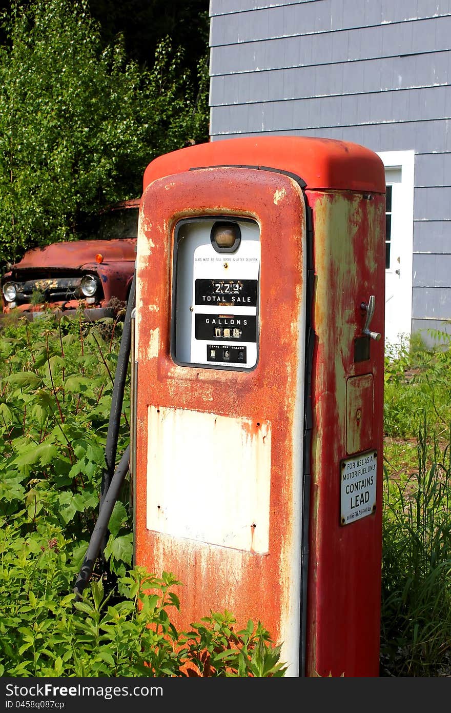 Vintage gas pump and truck at abandoned location