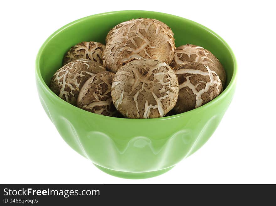 Fresh Shiitake Mushroom in a green bowl, isolated on white