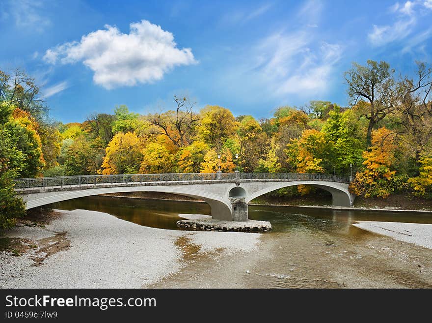 Lonely stone bridge over autumnal scene in Munich. Lonely stone bridge over autumnal scene in Munich