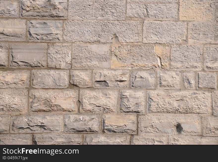 Pattern of grey - light brown limestone wall