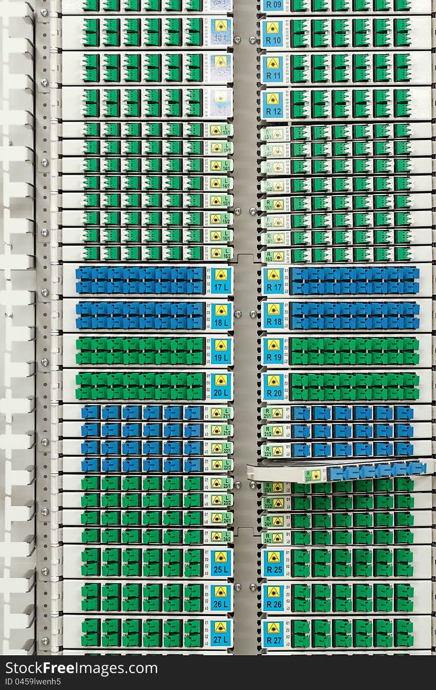 Fiber optic cable management system with green and blue SC connectors. Fiber optic cable management system with green and blue SC connectors