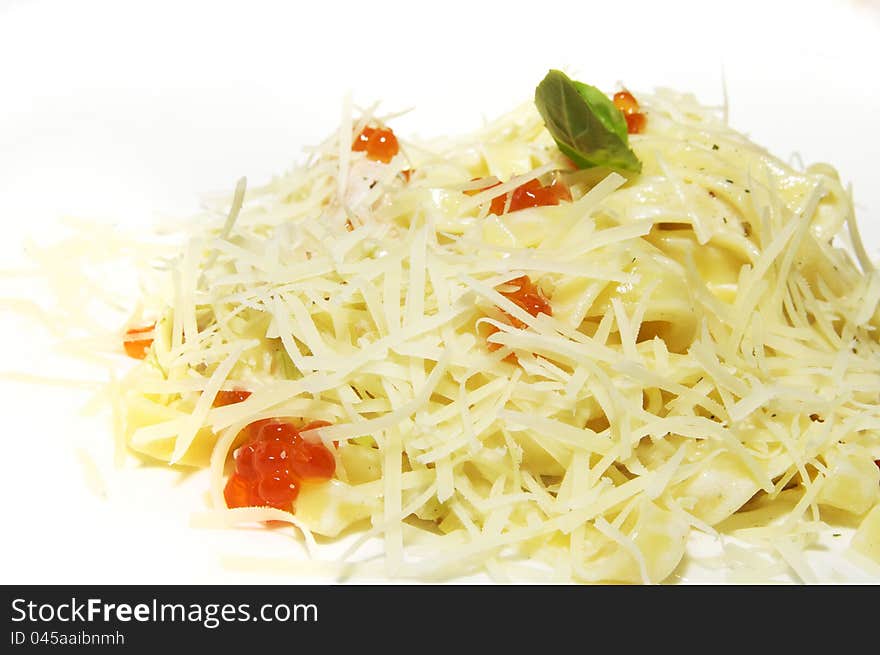 Spaghetti with red caviar on white dish