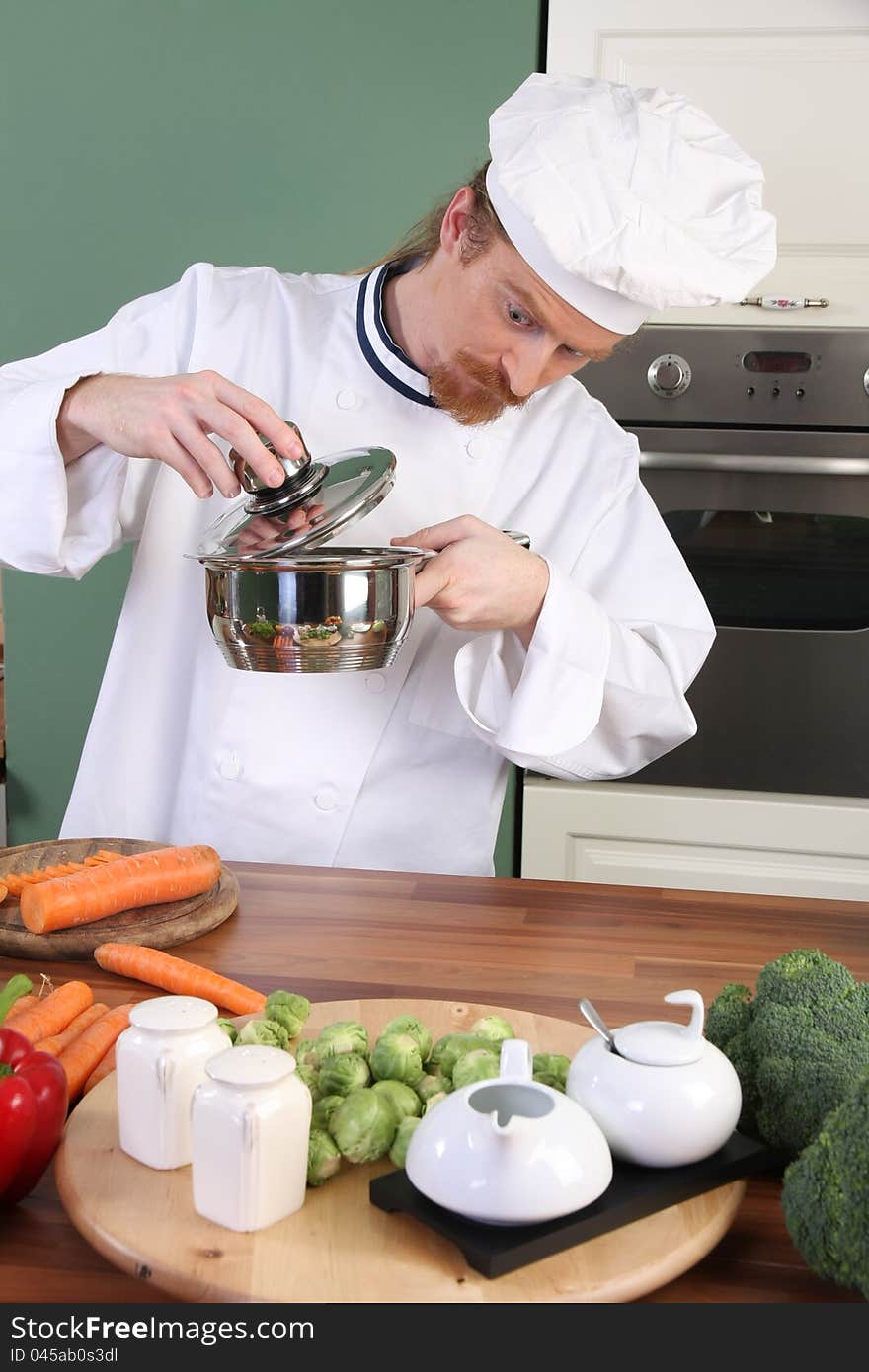 Funny young chef strange looking at pot