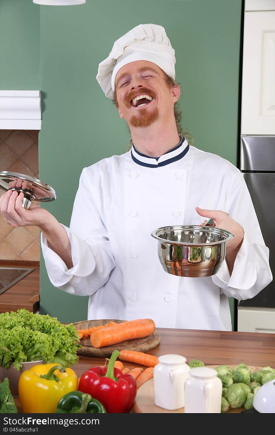 Young chef with vegetables, preparing lunch in kitchen. Young chef with vegetables, preparing lunch in kitchen