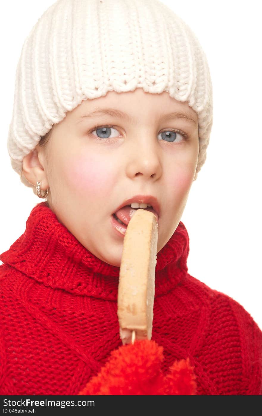 Girl with a winter hat and sweater eating ice cream. Girl with a winter hat and sweater eating ice cream